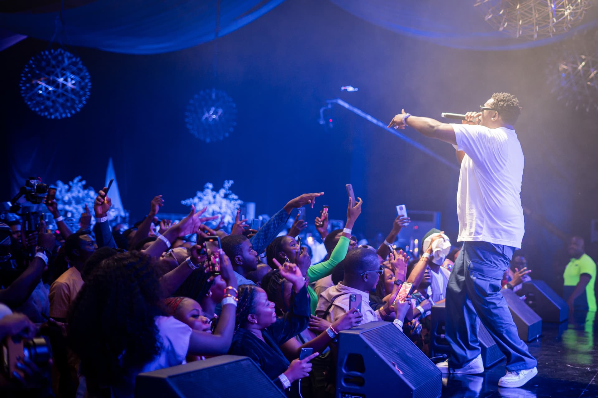 Live performer engaging an audience during an experience